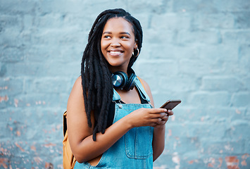 Image showing Social media phone, music headphones and black woman thinking of motivation going to university in city. African college student with vision for future listening to podcast on mobile in Canada