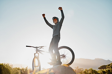Image showing Mountain bike winner or motorcycle man with success, yes or fist pump for fitness achievement goal or motivation outdoor and blue sky mockup. Sports person winning with adventure bicycle on a hill