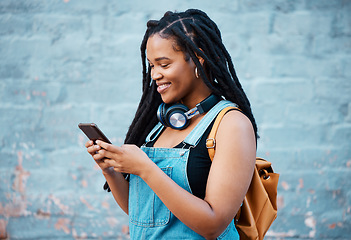 Image showing Black woman, smile and phone of a student from Jamaica with technology and headphones. Happy, urban and gen z person using 5g internet, web and social media app scroll while texting with happiness