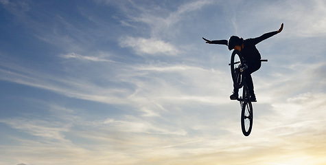 Image showing Mountain bike man, sky jump and energy of action, freedom and competition silhouette, shadow and mockup. Professional cycling athlete in air, danger performance and bicycle risk on background clouds
