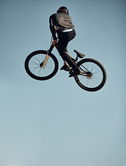 Image showing Cycling, bicycle and man doing a sky jump trick for a sports freestyle competition, game or travel race. Air mockup, energy and mountain bike person doing exercise, workout or fun fitness training