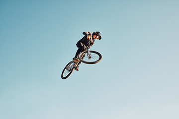 Image showing Motorcycle stunt, man cycling in air jump on blue sky mock up for sports action performance, fitness training or outdoor bike performance. Professional sports person with bmx bicycle adventure mockup