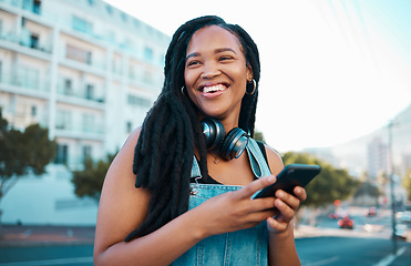 Image showing Student, street and happy girl with smartphone enjoying leisure break on weekend in Los Angeles. Black woman hipster with smile on commute with phone and headphones for music streaming in city.