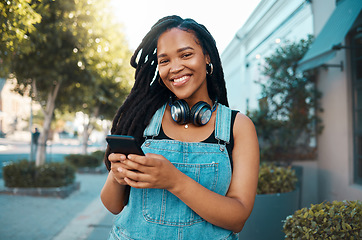 Image showing Happy black woman in the city, in conversation on smartphone and texting on social media. Walking the street, urban black girl smiling and using 5g connection for mobile communication with happiness