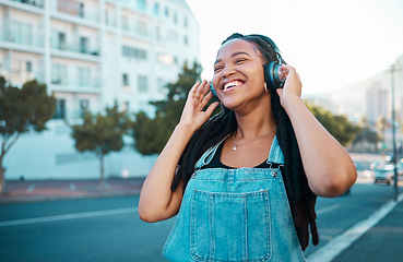 Image showing Music headphone city streaming, happy and black woman smile outdoor from Atlanta. Happiness of a person feeling relax freedom and cheerful mindset listening to audio and song track near the street