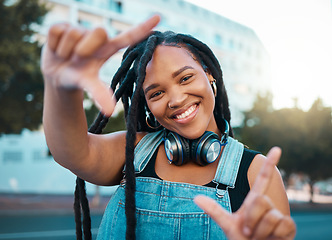 Image showing Hands frame, city portrait and black woman with headphones for music during travel holiday in Italy. Happy, and young African girl with perspective, inspiration and vision on fun vacation in summer