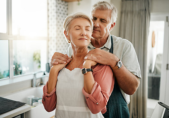 Image showing Senior, couple and love in kitchen for embrace together in romance, care and bonding in home. Elderly man, woman and retirement show happiness, relax and happy look on face in house in Houston, Texas