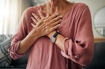 Image showing Senior woman, hands or chest pain in heart attack, anxiety or panic in house or home living room. Zoom, stroke or cardiovascular emergency for sick retirement elderly or stress person in medical risk