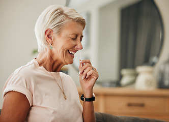 Image showing Covid, antigen rapid test and woman with nose swab for health, illness, or virus PCR results of senior with at home. Elderly lady, coronavirus and laughing using nasal stick for possible infection