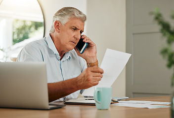 Image showing Senior man on a phone call with finance documents for debt counselling. Old male at home with his laptop and paperwork to check finances, accounting and payments, using his mobile phone for help