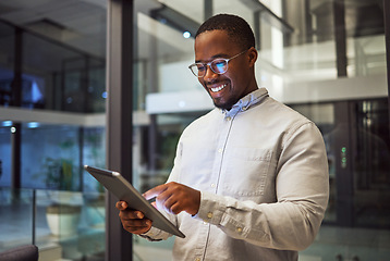 Image showing Night business. tablet and black man typing and reading information online doing research and smiling at good results working late. Happy male on internet for marketing strategy in Nigeria office