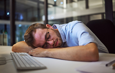 Image showing Night sleep, business burnout and businessman sleeping at his desk in his dark office at work. Tired corporate employee, worker or manager with stress taking a nap at a table while working overtime