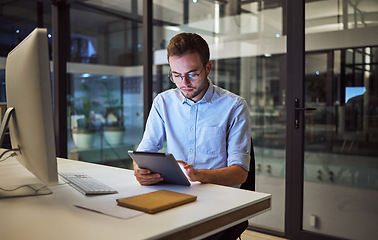 Image showing Business, communication and overtime, man with tablet and computer at desk. Late night at office, working on deal or internet project. Corporate worker in glasses, checking online financial report.