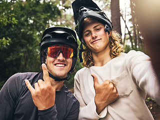 Image showing Friends in forest, cool fitness selfie fitness with cycling helmet and smile with hands gesture in Australia. Workout on bicycle trail, fun travel adventure and outdoor sports training in green woods