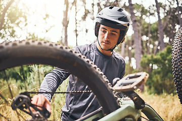 Image showing Mountain bike, fitness or cyclist fixing chain in exercise, training or workout in Norway forest or nature woods. Thinking man, bicycle or sports athlete and helmet or motivation in equipment repair