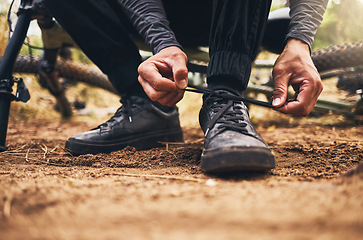 Image showing Man outdoor shoes, ready for exercise training with bike and travel sports. Cardio adventure on mountain bicycle trail, cyclist prepare for start of fitness and closeup cyclist tie shoelace on ground