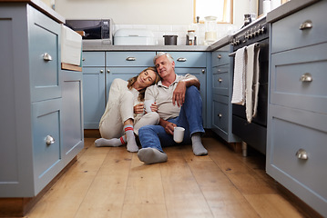 Image showing Coffee breakfast, relax and senior couple with smile on the kitchen floor in the morning in their house. Calm elderly man and woman in retirement talking with tea and love in marriage in home
