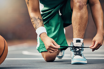 Image showing Basketball player shoes on court, start game and hands tie sneakers shoelaces with ball. Sports man prepare for competition, player training in summer and strong athlete kneeling ready for workout