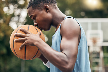 Image showing Sports, fitness and man with a kiss to a basketball in training, workout and athletic exercise outdoors. Culture, wellness and young player or athlete with passion and love for playing on court