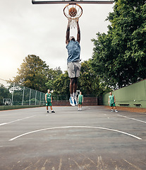 Image showing Basketball, player and winner on court jump, makes basket and score, celebration and victory playing against team. Competition, game day and dunk ball in net excited, practice and winning the game.