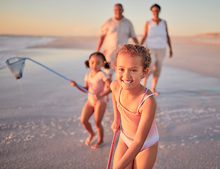 Image showing Children, fishing and family with a girl at the beach with her grandparents and sister for summer holiday. Kids, happy and ocean with a child on sand by the sea with her grandmother and grandfather