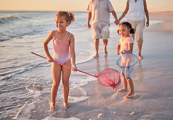 Image showing Beach, fishing and children with parents in water for summer vacation, holiday or outdoor growth development and wellness. Happy, excited girl kids and fisherman people or family play with net in sea