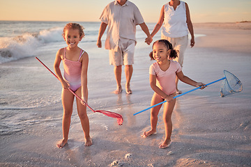 Image showing Children, fishing and beach with a girl, family and sister on the sand by the sea or ocean for fun and playing. Water, nature and kids playing outside during summer vacation, holiday or getaway