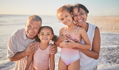 Image showing Family, children and beach with a girl, grandparents and sister on the sand by the ocean or sea at sunset. Kids, summer and travel with a grandfather, grandmother and grandchildren on holiday