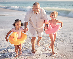 Image showing Children, beach and family with a girl, grandfather and sister playing on the sand by the sea or ocean in summer. Water, travel and fun with a grandparent, grandchild and sibling outdoor on holiday