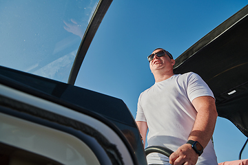 Image showing Man on luxurious yacht on the open sea, relaxing in the warmth of the sun, as they enjoy a day filled with adventure and friendship.