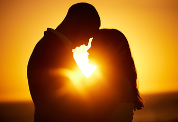 Image showing Silhouette, sunset and couple on honeymoon love bonding, hugging and enjoying quality time together in Los Angeles. Romantic woman and partner on holiday vacation in a dark night on Valentines day