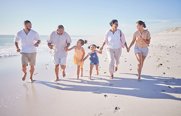 Image showing Happy, children and family running on beach together while parents and grandparents smile or follow. Carefree kids having fun during summer beach vacation in California with happiness, love and laugh