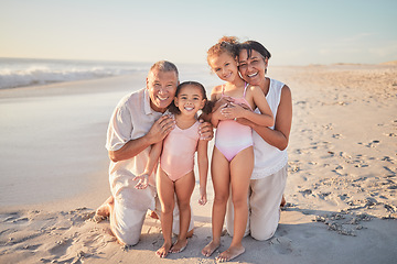 Image showing Grandparents with children, happy on beach on holiday and enjoying retirement. Grandpa, grandma and kids enjoy afternoon playing in ocean summer sun. Family love time together by the sea and sand