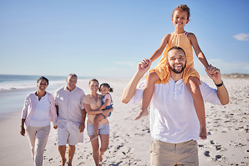 Image showing Beach, father carry girl on walk with family, grandparents and children on holiday, vacation and break. Happy, smile and excited parents with kids enjoy weekend getaway having fun and relax on sand.