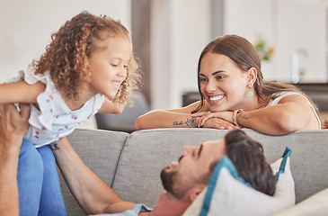 Image showing Mom, kid and father playing on sofa lounge at family home in Colombia for love, care and quality time together. Smile parents, excited laughing child and relax living room for fun, happiness and joy