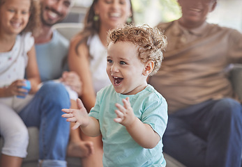 Image showing Baby, clapping hands and excited toddler boy feeling happy, playful and cheerful at home with his family showing growth, development and having fun. Cute child playing in his new Zealand house