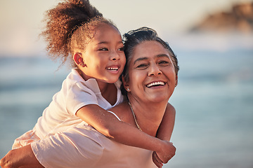 Image showing Family, children and beach with a girl and grandmother outdoor by the sea or ocean during summer. Happy, smile and face with a woman and granddaughter spending time outside together in nature