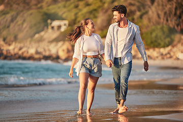 Image showing Love, travel and happy with couple at the beach holding hands on Cancun summer vacation for relax, peace and support. Sunset, ocean and smile with man and woman walking on Mexico holiday together