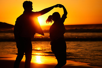 Image showing Sunset, dance and silhouette of couple by the beach together for love, travel and Puerto Rico holiday. Summer, sunrise and nature with man and woman dancing by the sea for vacation, happy and relax