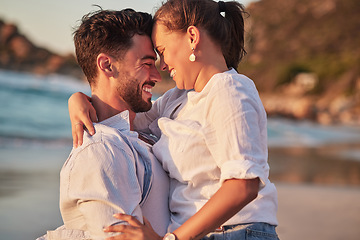 Image showing Couple, laughing or love hug on beach at sunset for anniversary event, honeymoon celebration or engagement. Smile, happy or comic man and woman bonding in summer by tropical ocean or sea in Portugal