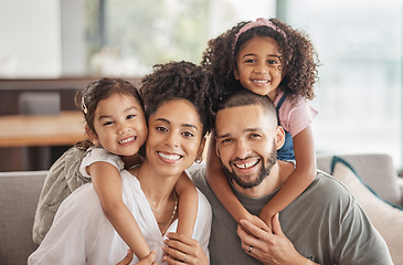 Image showing Happy, smile and portrait of an interracial family sitting on a sofa in the living room at home. Happiness, love and adoptive parents bonding, embracing and relaxing with their children in the lounge