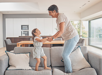 Image showing Grandma jump and girl on sofa in fun play, happy together and excitement at home. Happy energetic family playing on couch excited in joyful entertainment for free time leisure with smile and love