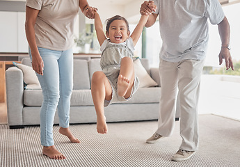 Image showing Family, child holding hands and swinging in fun living room play time, childhood and bonding at home. Happy kid smile in playful childcare and joyful happiness with loving parents or grandparents