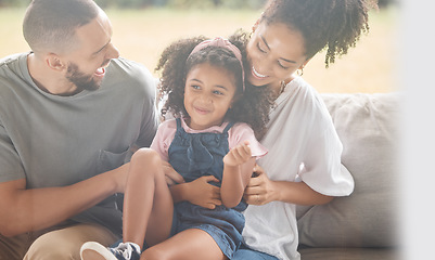 Image showing Love, relax and happy family laughing on a sofa, bonding and playing in living room together. Fun, cheerful and caring parents enjoy game with little girl, quality time and happiness by black family