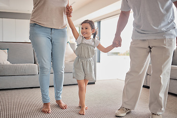 Image showing Kids, family and love with a girl, mother and father holding hands in the living room of their home. Children, smile and care with a happy female child and parents in a house on a weekend morning