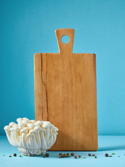 Image showing wooden cutting board and mushrooms