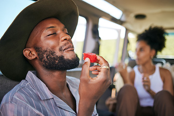 Image showing Black man, eating watermelon and summer fruit on safari game drive in sustainability nature or environment landscape travel. Smile, happy tourist or couple and diet health food in Kenya national park