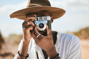Image showing Tourist, photographer and black man with camera to take photograph or pictures during travel adventure in summer on nature vacation. Closeup of male on photography trip holiday outdoors in safari