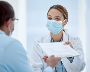 Image showing Doctor, woman and covid patient form for health consultation advice and records at hospital. Female healthcare nurse with mask offering document for vaccine agreement or pandemic safety regulations