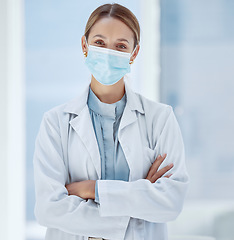 Image showing Woman, healthcare and covid face, mask rules with proud doctor working in a hospital, ready and confident. Health care professional leader work during pandemic, focused on helping sick people